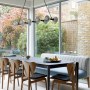 Between the Commons, SW11 | Bright dining area with upholstered bench | Interior Designers